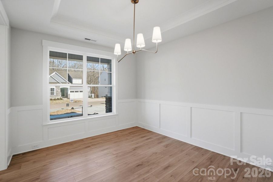 Dining room with Craftsman-style trim and tray ceiling