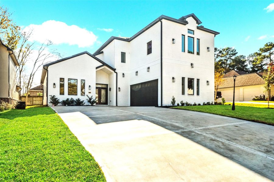 “Stunning modern custom home with striking curb appeal, a spacious driveway, elegant black-trim accents, and grand entry—true luxury living.”