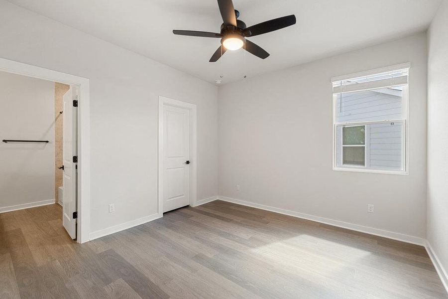Unfurnished bedroom with light wood-style floors and ceiling fan