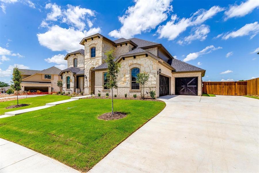 View of front of home with a garage and a front yard