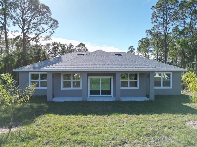 Front exterior of a new home in , Palm Bay, FL, highlighting curb appeal (Image 1).