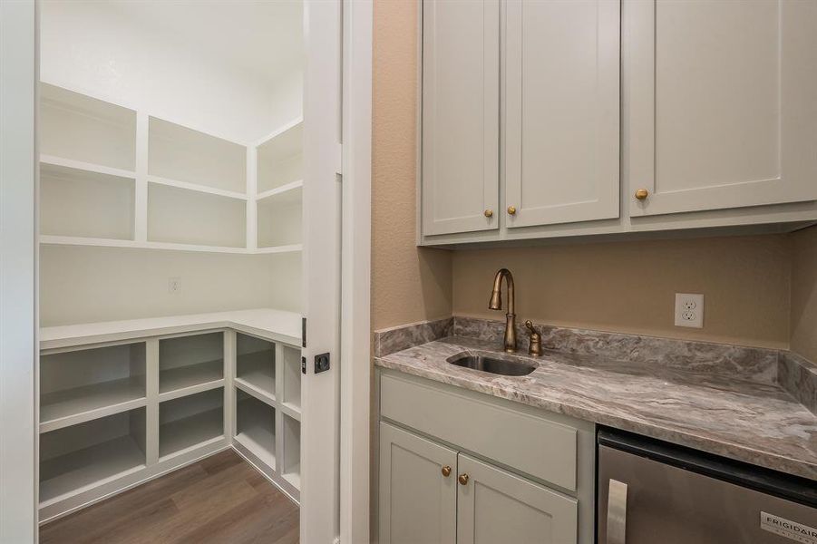 Oversized pantry just off the kitchen and wet bar area.