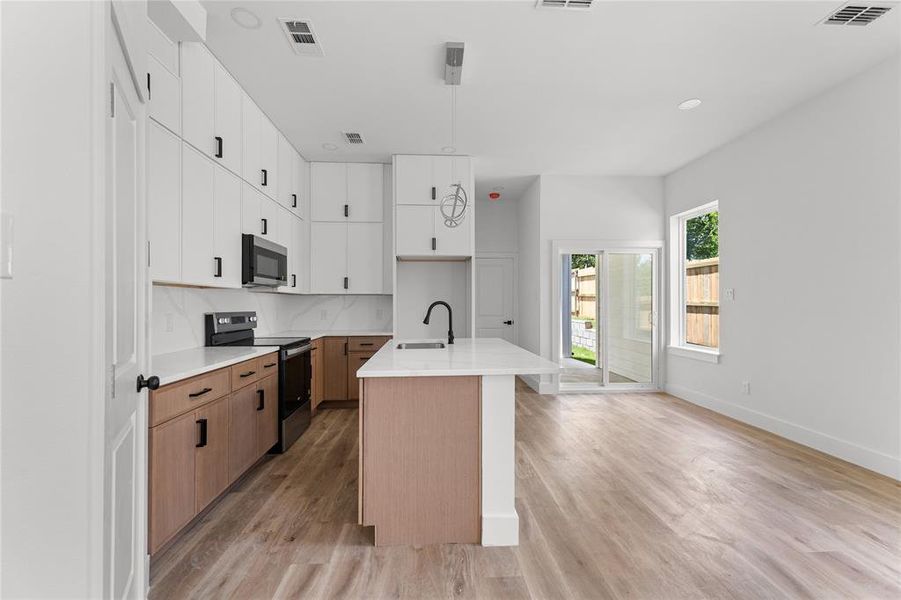 Unit 522 - Identical floor plan with warm espresso cabinetry. Available separately or purchase both units as investment duplex.