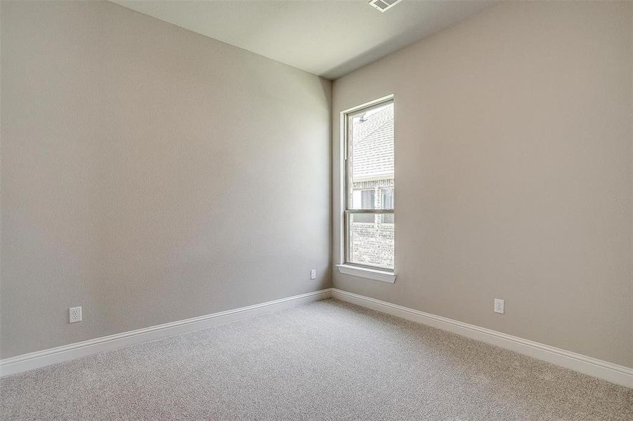 Carpeted empty room featuring a healthy amount of sunlight