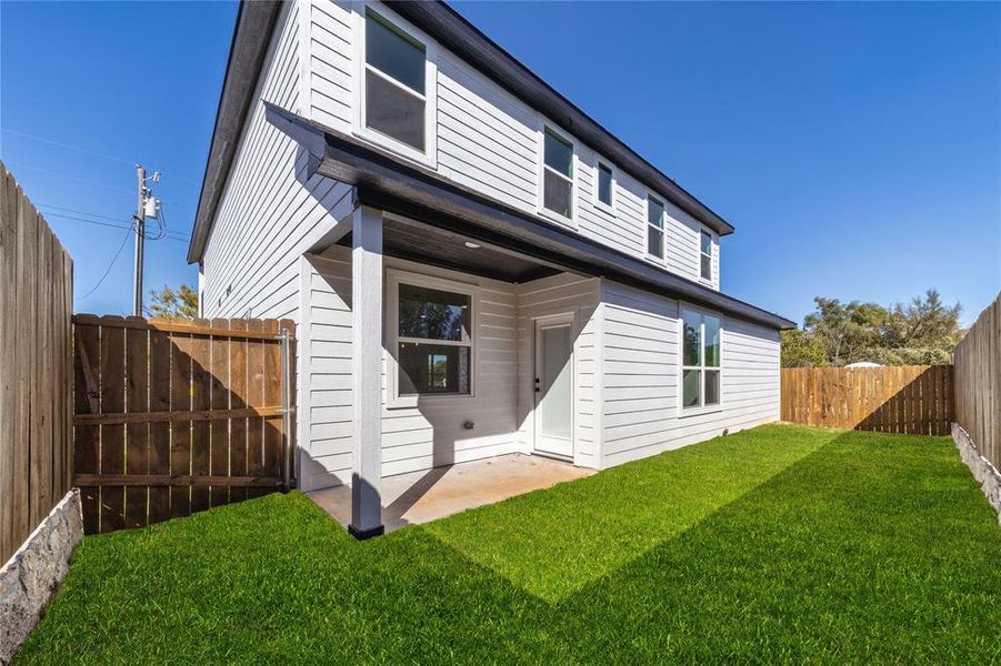 Rear view of house featuring a patio area and a fenced backyard Rear view of house featuring a patio area and a fenced backyard