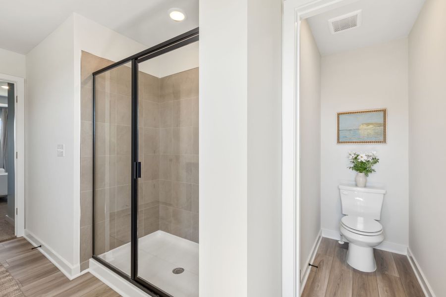 A bathroom with a glass shower. A bathroom with a glass shower.