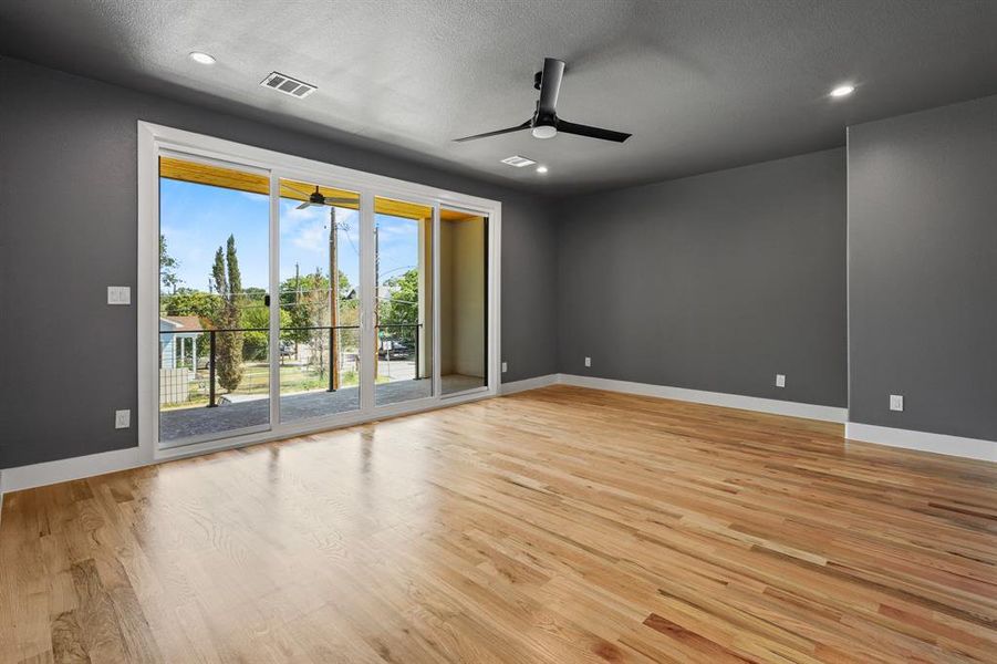 Spare room featuring ceiling fan, light wood-type flooring, and a textured ceiling