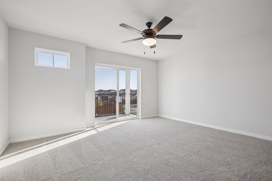 A room with a ceiling fan and a window.