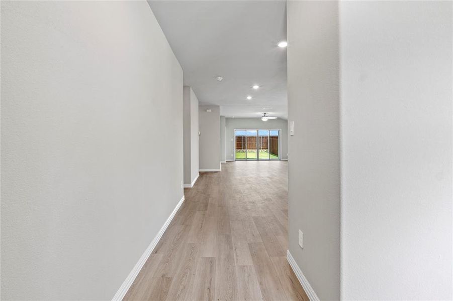 Hall featuring light wood-style floors and recessed lighting Hall featuring light wood-style floors and recessed lighting