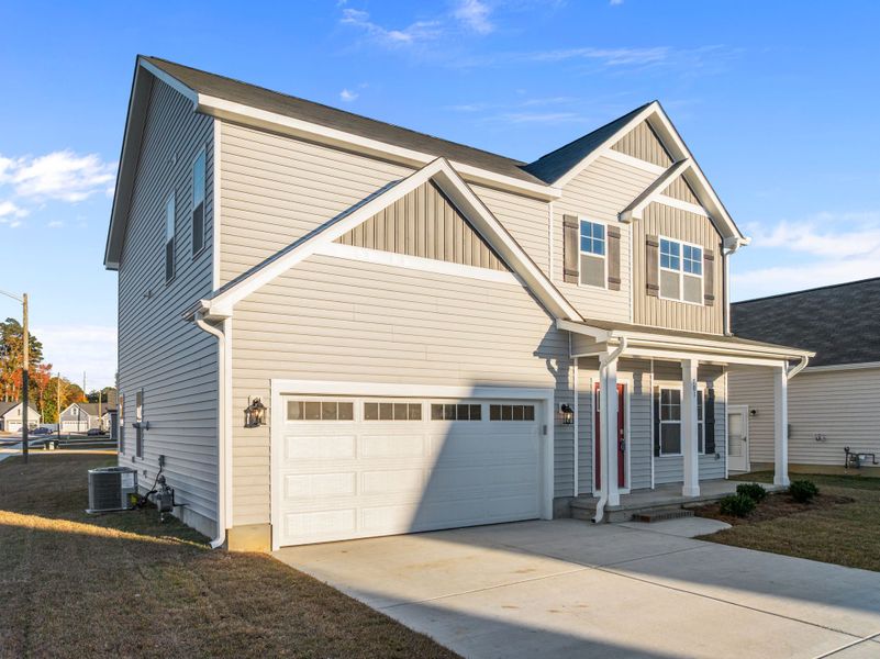 Front exterior of a new home in Arbor Hills South, Greenville, NC, highlighting curb appeal (Image 24). Front exterior of a new home in Arbor Hills South, Greenville, NC, highlighting curb appeal (Image 24).