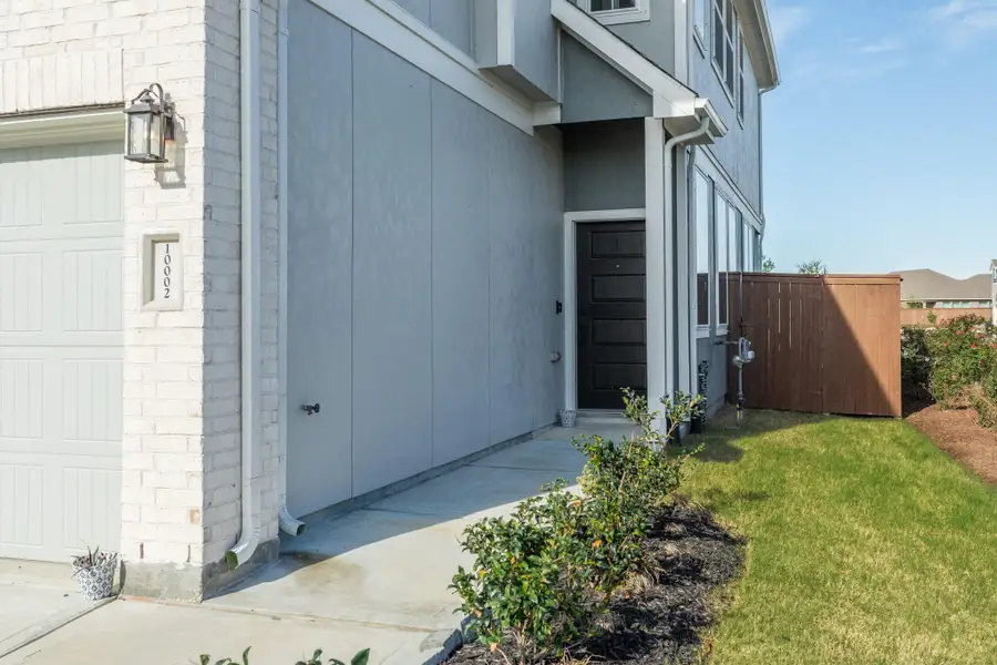 Wooden front door situated on the side of the residence.