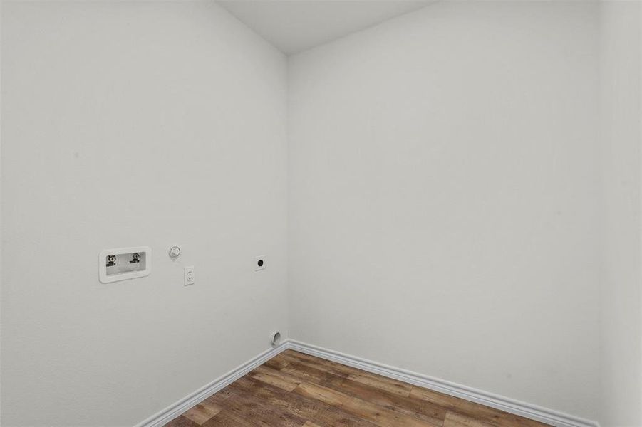 Laundry room with gas dryer hookup, washer hookup, dark hardwood / wood-style floors, and hookup for an electric dryer