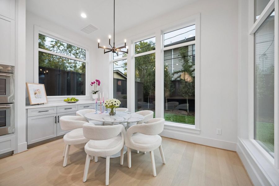 Breakfast area with built-in Buffet and storage drawers/cabinets. There is also a 6 Light 26" Wide Chandelier.