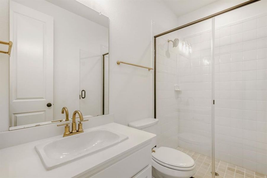 Full bath with vanity and a stall shower