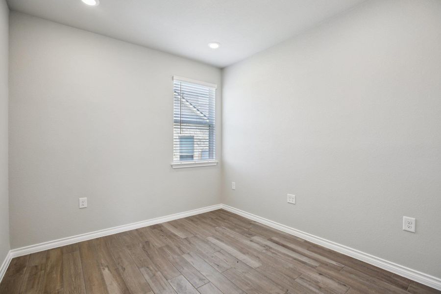 Empty room featuring wood finished floors and recessed lighting Empty room featuring wood finished floors and recessed lighting