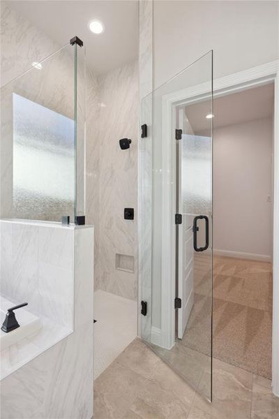 Bathroom featuring a shower with door