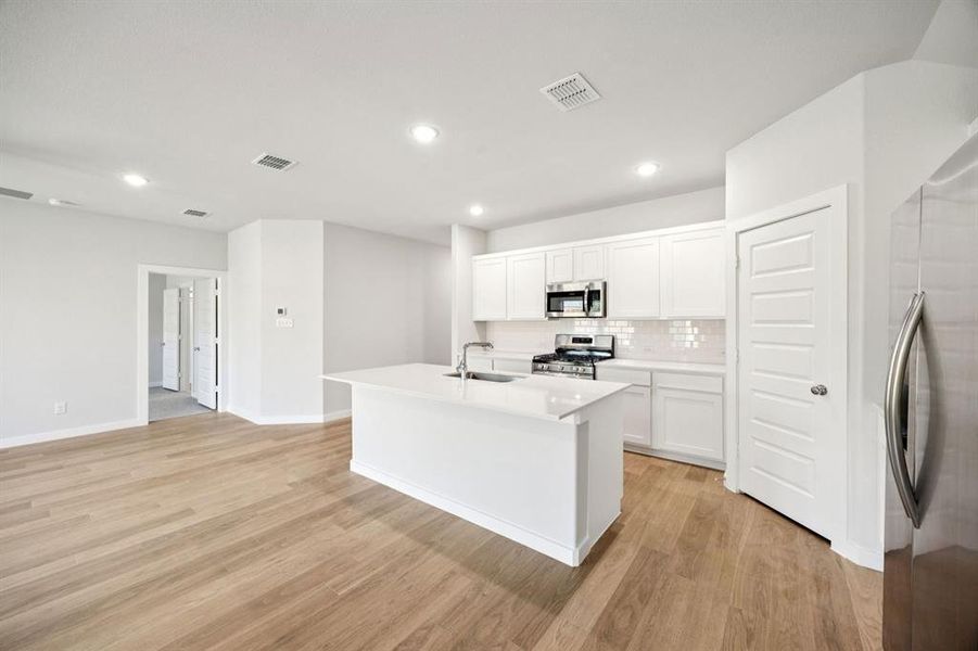 Kitchen in the Emmy II home plan by Trophy Signature Homes - REPRESENTATIVE PHOTO
