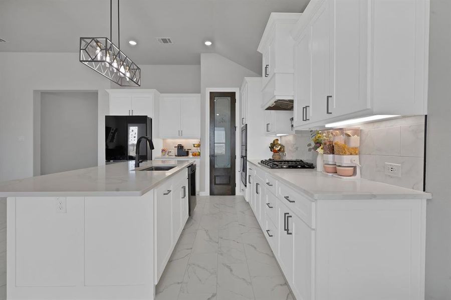 Kitchen featuring gas stovetop, marble finish floor, premium range hood, and white cabinets