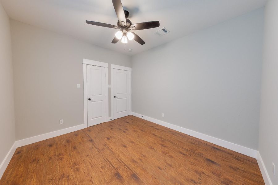 Comfortable secondary bedroom with a ceiling fan, providing a cool and relaxing space for rest and relaxation.