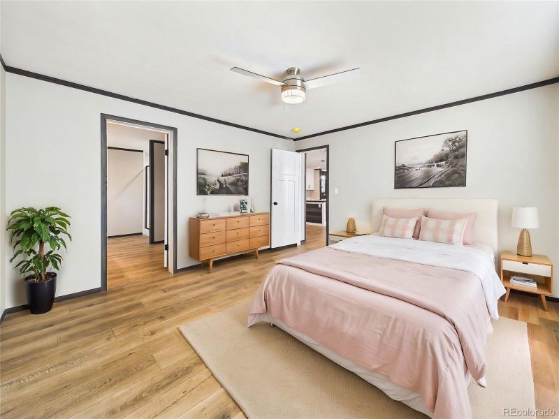 (Virtually Staged) – Inviting bedroom with staged furnishings that illustrate a cozy and stylish setup, complete with warm accents and natural light.