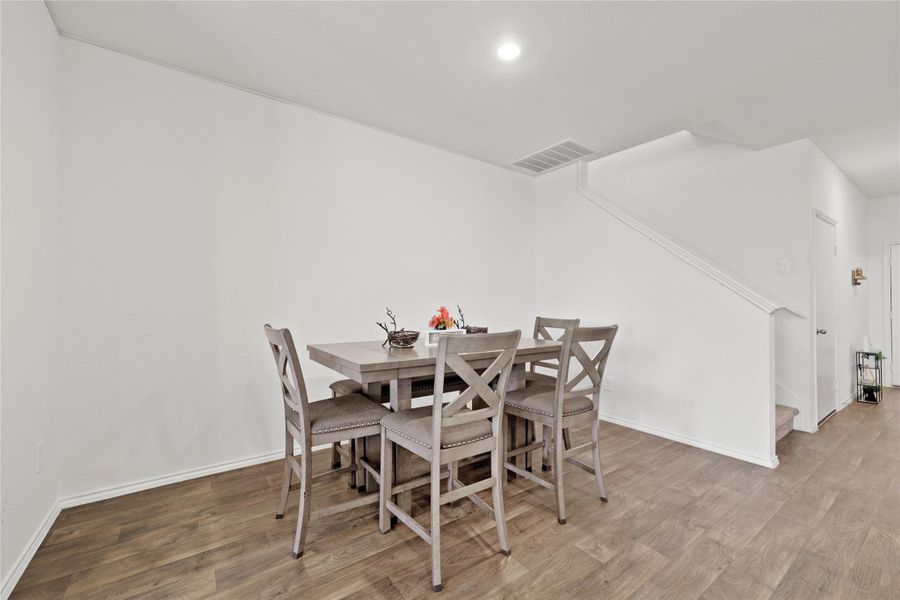 This spacious dining area is perfectly positioned for entertaining, offering plenty of room for a large table where guests can gather right in the center of the action.