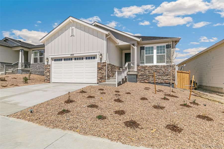 Front exterior of a new home in Terrain Oak Valley, Castle Rock, CO, highlighting curb appeal (Image 24). Front exterior of a new home in Terrain Oak Valley, Castle Rock, CO, highlighting curb appeal (Image 24).