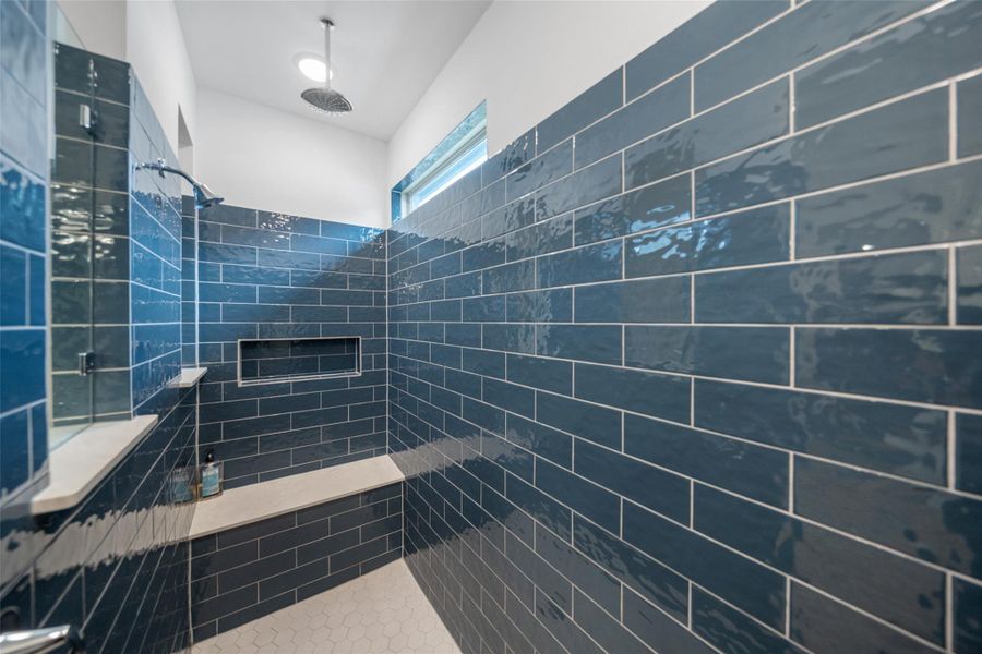 Bench and rain shower make the primary shower very functional.