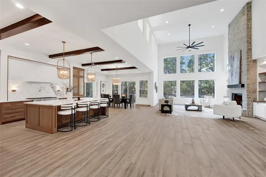 Gorgeous kitchen/living area. Features natural light, high-quality finishes, and functional elements for a warm, inviting atmosphere.