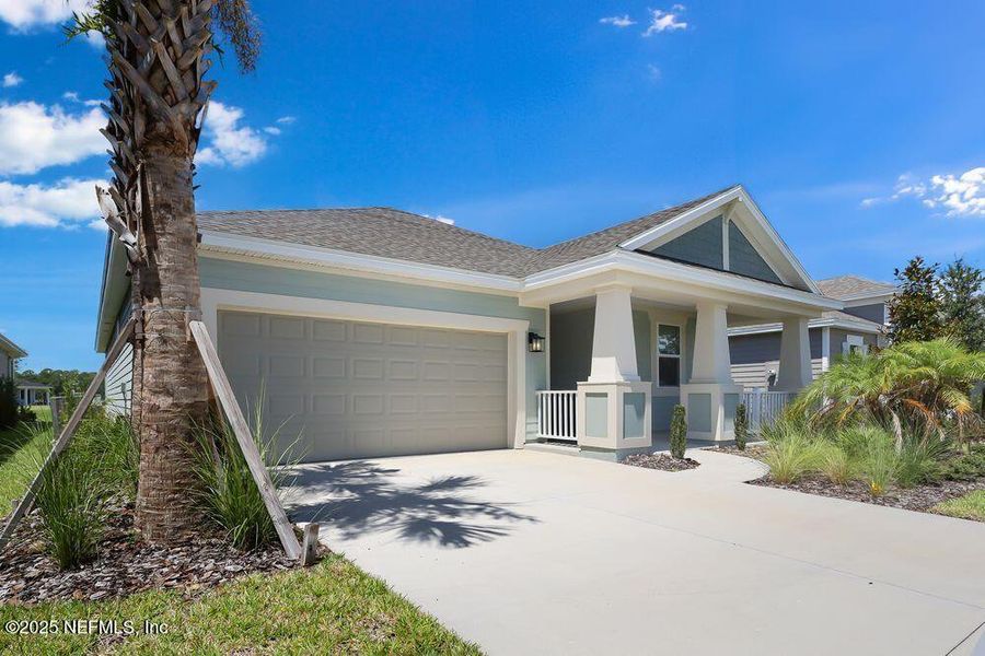 Front exterior of a new home in Colbert Landings, Palm Coast, FL, highlighting curb appeal (Image 1).