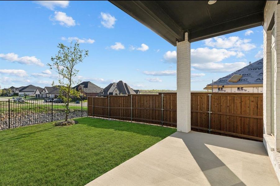 Fenced backyard featuring a patio area and a residential view