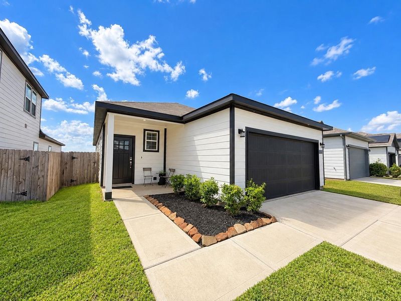 Front exterior of a new home in Paloma at Sanford Farms, Waller, TX, highlighting curb appeal (Image 2). Front exterior of a new home in Paloma at Sanford Farms, Waller, TX, highlighting curb appeal (Image 2).