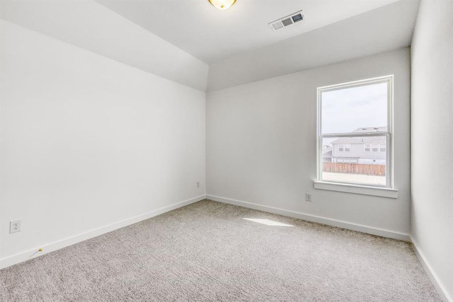 Empty room featuring carpet and baseboards
