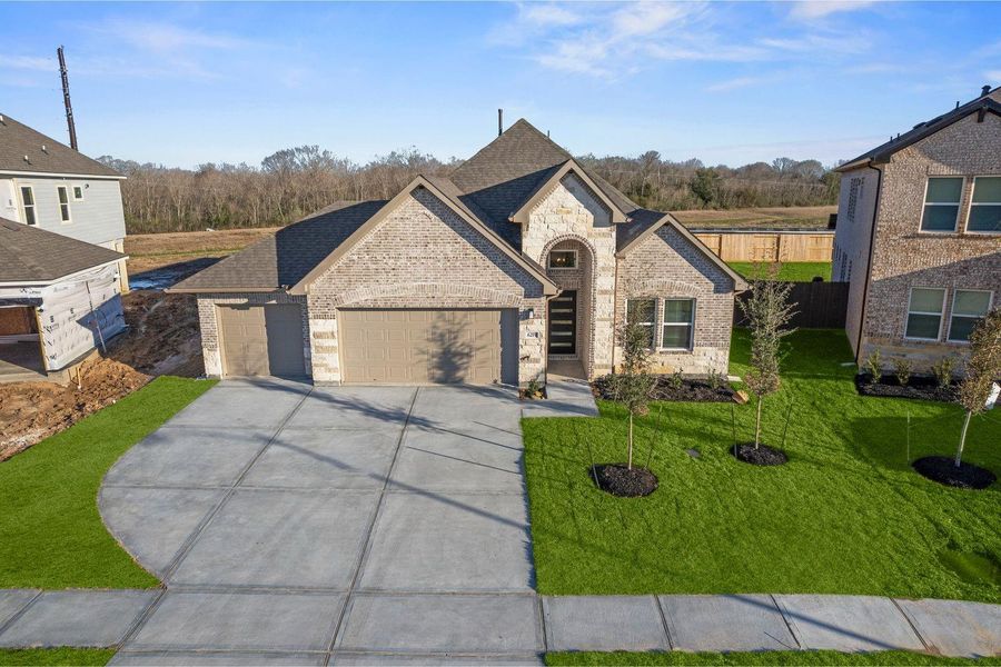 Front exterior of a new home in Foxtail Palms, Manvel, TX, highlighting curb appeal (Image 2). Front exterior of a new home in Foxtail Palms, Manvel, TX, highlighting curb appeal (Image 2).