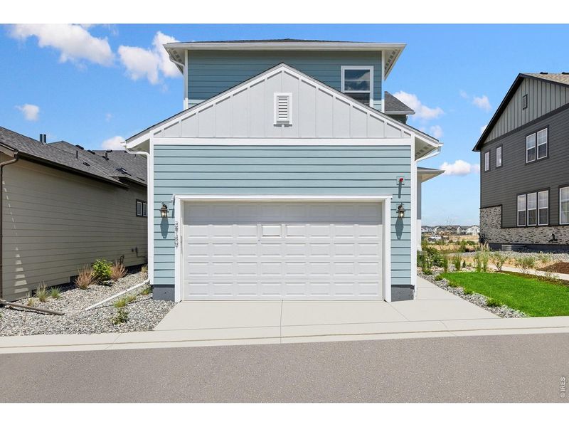 Front exterior of a new home in Kinston Cottage, Loveland, CO, highlighting curb appeal (Image 26). Front exterior of a new home in Kinston Cottage, Loveland, CO, highlighting curb appeal (Image 26).