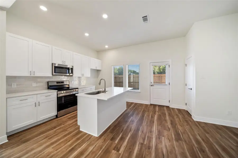 Granite counters, neutral backsplash.
