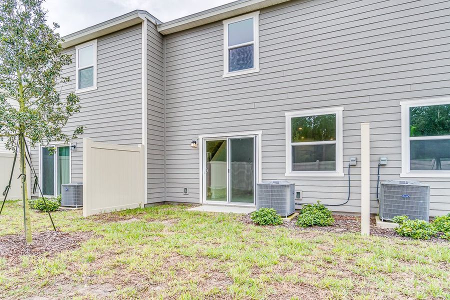 Exterior details and patio area of a home in Orchard Park Townhomes, St. Augustine (Image 2).