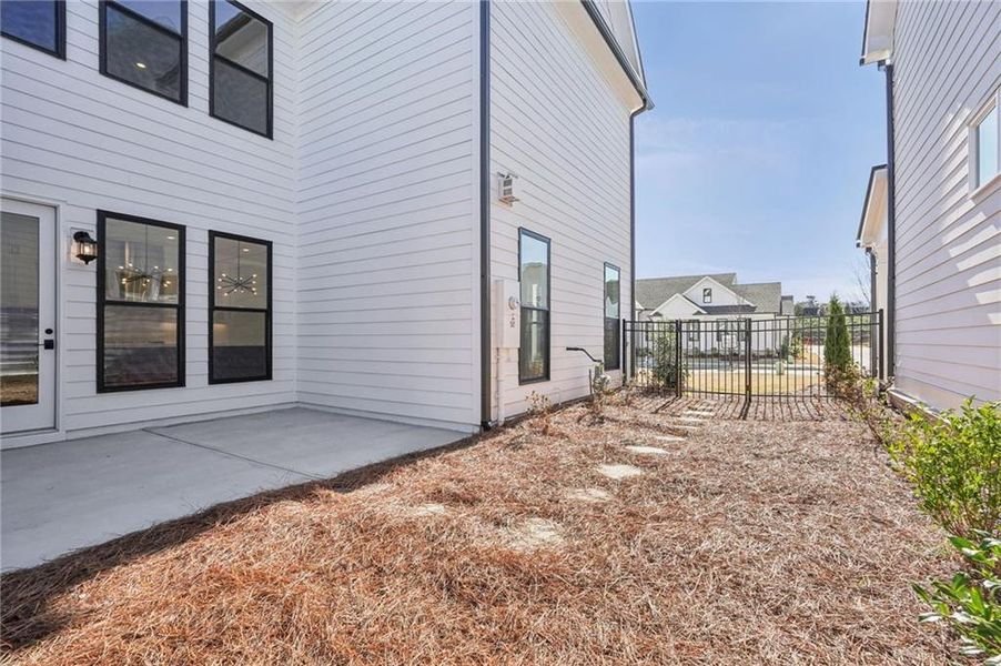 Exterior details and patio area of a home in Promenade at Sawnee Village, Cumming (Image 27).