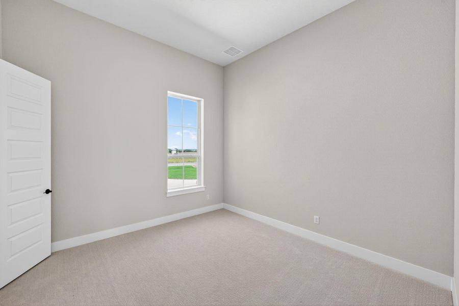 Empty room with light colored carpet and baseboards Empty room with light colored carpet and baseboards