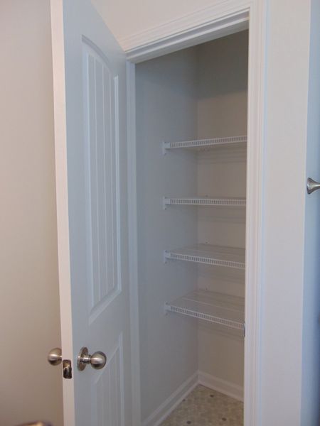 The linen closet within the second bathroom