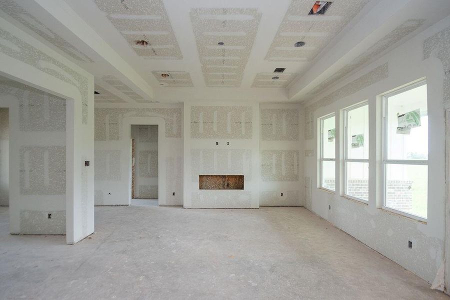 Spacious unfinished family room with large windows, electric fireplace allowing abundant natural light, ready for your personalized touch. Spacious unfinished family room with large windows, electric fireplace allowing abundant natural light, ready for your personalized touch.