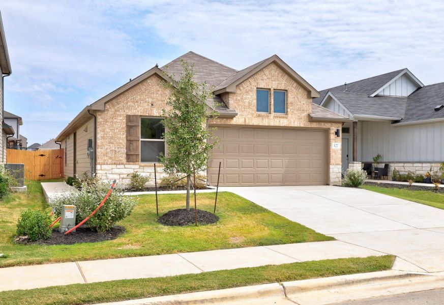 Front exterior of a new home in Trinity Ranch, Elgin, TX, highlighting curb appeal (Image 19).
