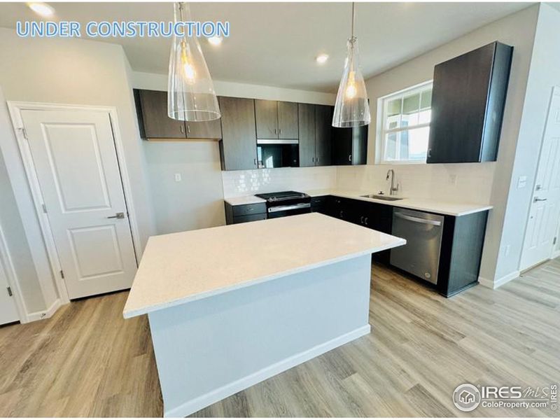 Beautiful upgraded kitchen with soft close cabinetry, gas cooking and quartz countertops