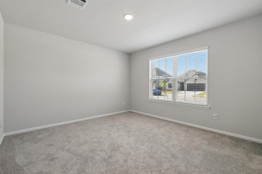 Carpeted spare room featuring baseboards Carpeted spare room featuring baseboards