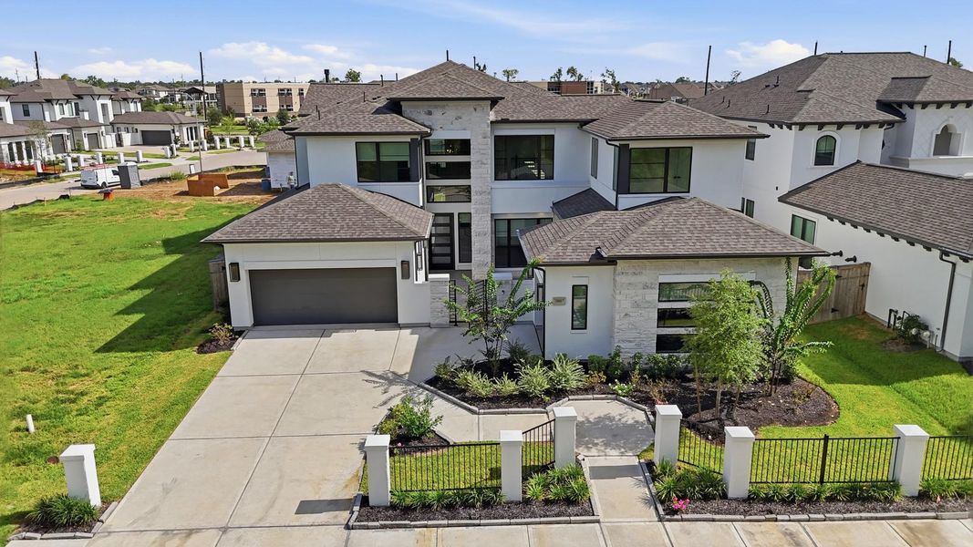 Front exterior of a new home in Sienna, Missouri City, TX, highlighting curb appeal (Image 23).