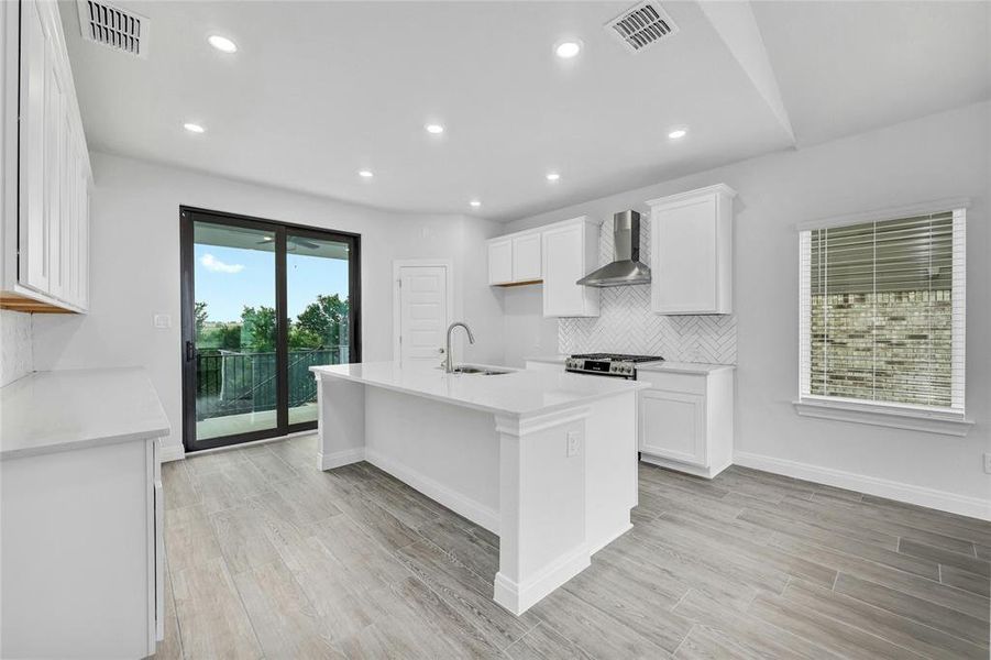 Kitchen leads to the back patio with a sliding glass door