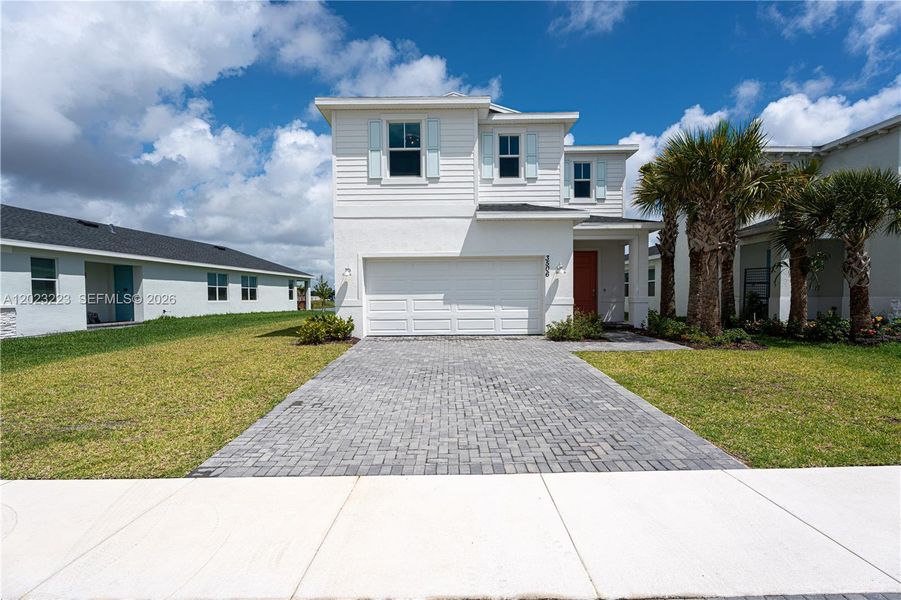 Front exterior of a new home in Seagrove, Fort Pierce, FL, highlighting curb appeal (Image 2). Front exterior of a new home in Seagrove, Fort Pierce, FL, highlighting curb appeal (Image 2).