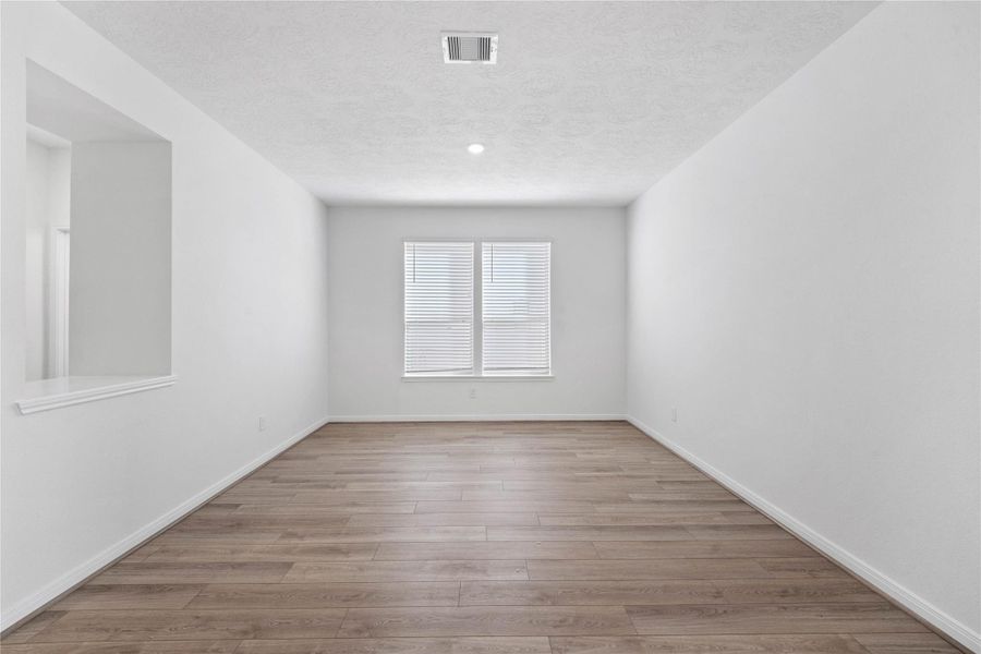 The Flex Room is versatile space that can be used as a formal dining or living room. It features Bandera vinyl plank flooring in French Oak, high ceilings, large windows with privacy blinds and neutral paint.