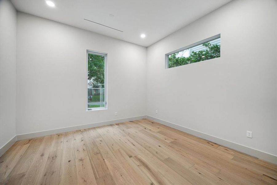 Secondary bedroom with windows strategically placed for picturesque view of the surrounding trees.