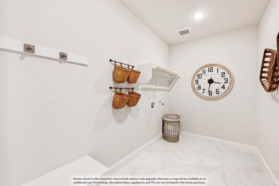 Laundry room with white walls, wall-mounted shelving, wicker baskets, and marble-look tile floors Laundry room with white walls, wall-mounted shelving, wicker baskets, and marble-look tile floors