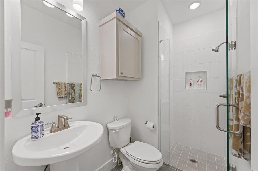 Downstairs guest bathroom features walk in shower added upgrade